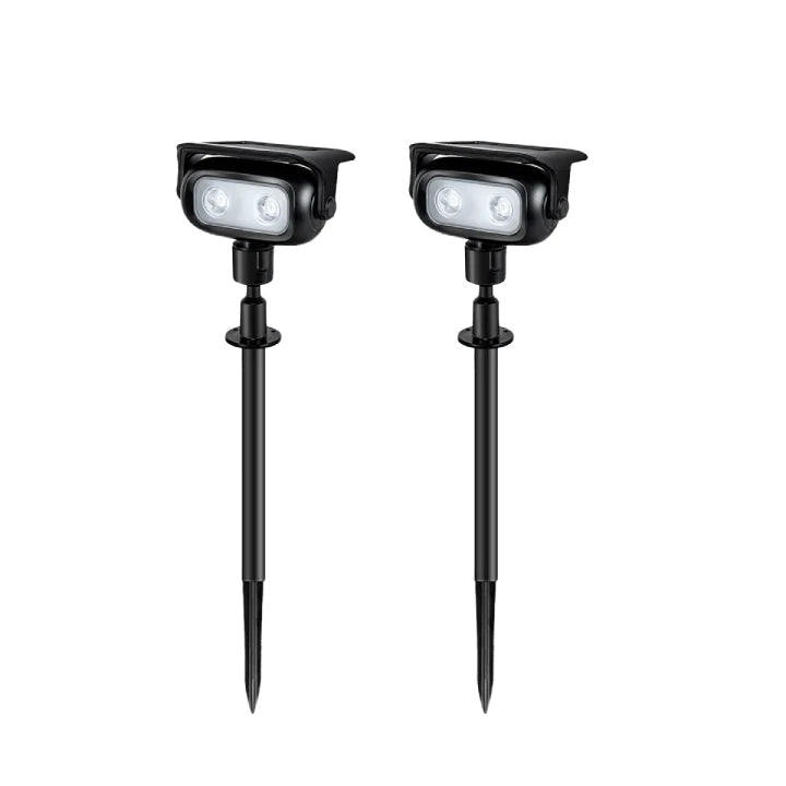 Ollny solar spotlights illuminating a dark garden pathway at night